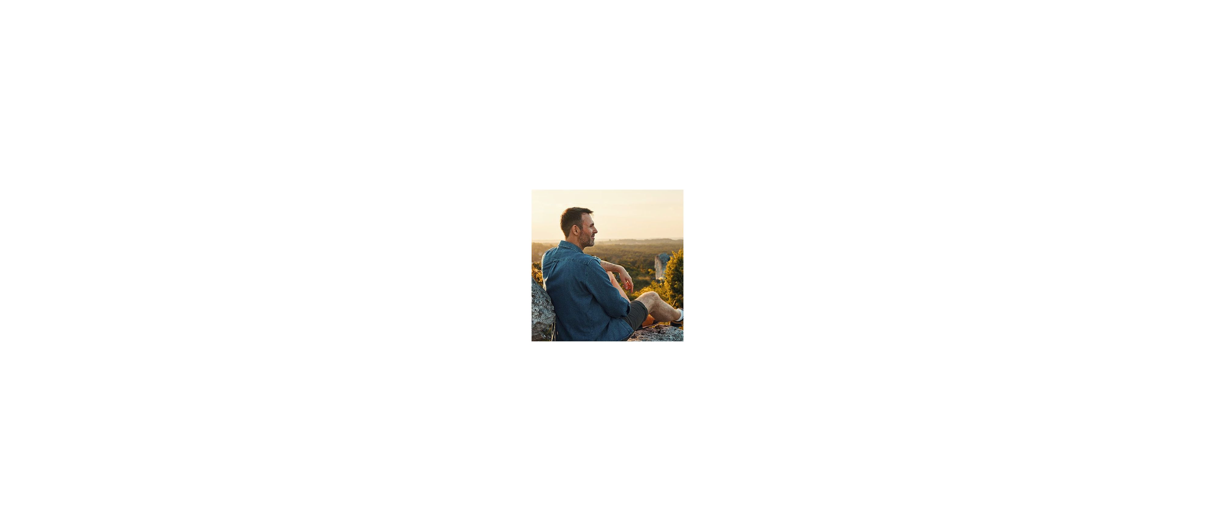 Man sitting outside in nature and enjoying the afternoon