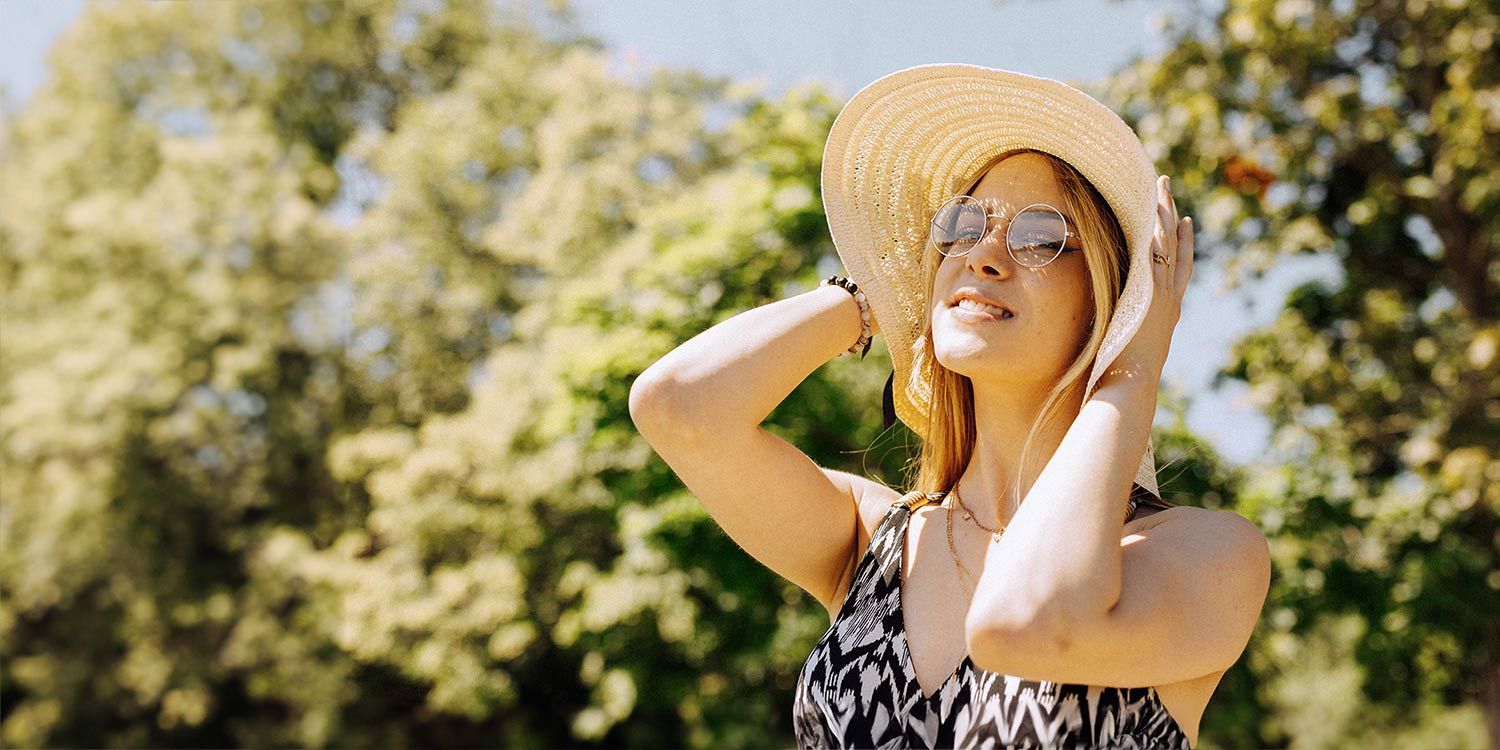 Woman in sun hat enjoying the sun