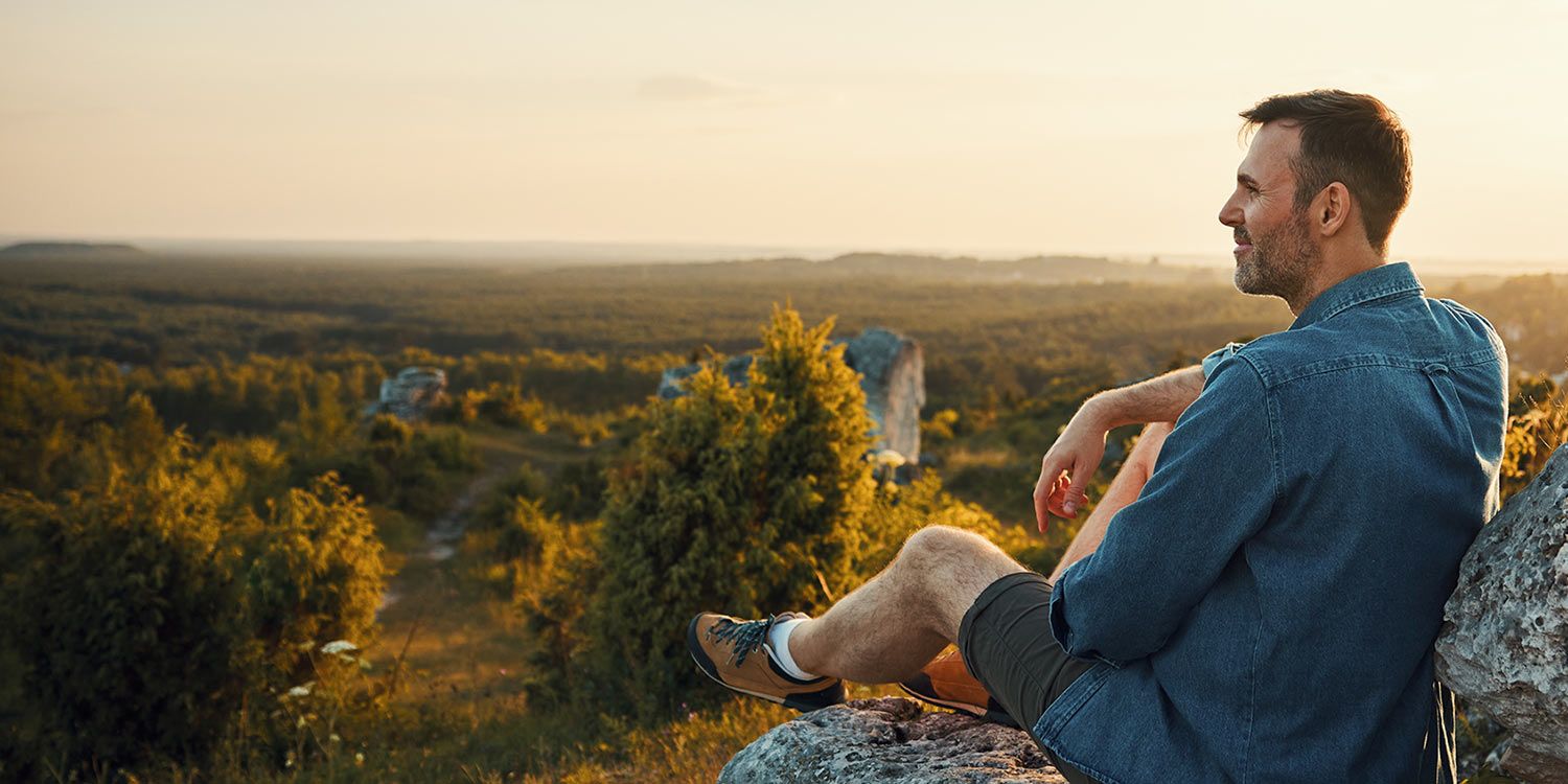 Man sitting outside in nature and enjoying the afternoon