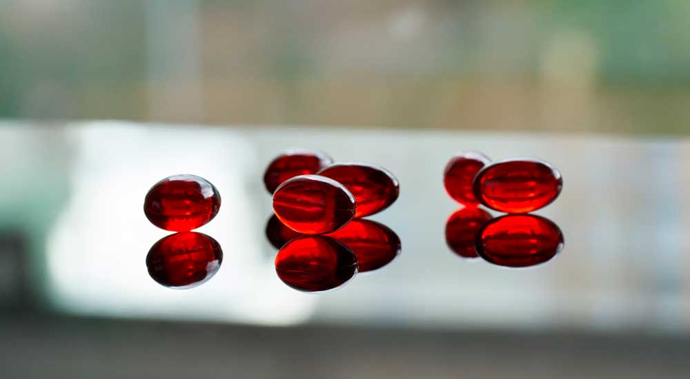 A close-up of red krill oil capsules