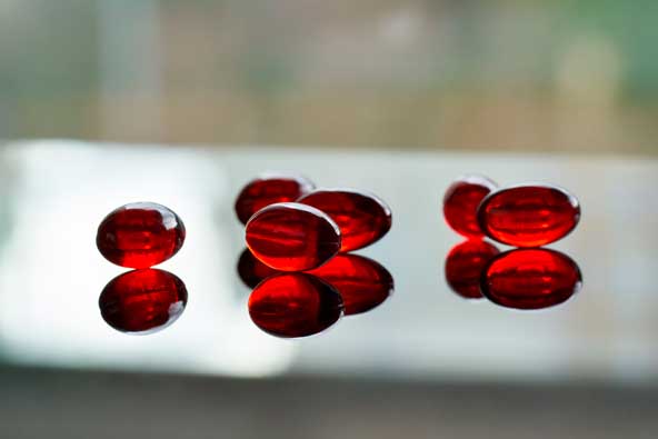 A close-up of red krill oil capsules