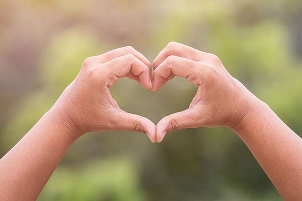 Two hands held up in the shape of a heart