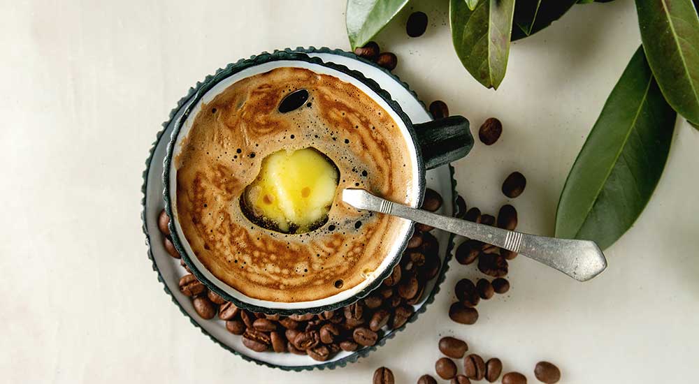 A cup of coffee with a dollop of butter