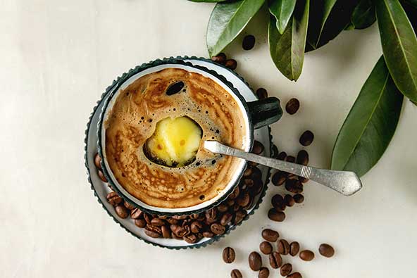 A cup of coffee with a dollop of butter