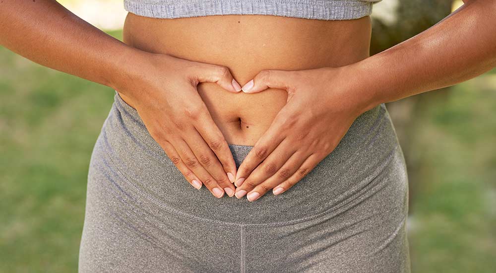 Woman holding hands on stomach