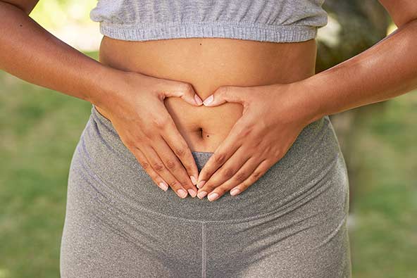 Woman holding hands on stomach