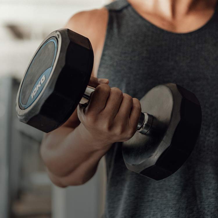 Hand lifting a heavy dumbbell for strength training